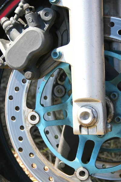 Close up of a motorbike wheel and disk brakes