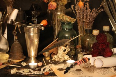 Kara büyü büyü. Wiccan büyüler ve otlar. Hala canlı: Eski yağ lambaları, antika kitap, bakır kase, ilaç şişeleri, lavanta, Pulsatilla pratensis bir antika arka plan üzerinde yanan bir muma gül tomurcukları kurutulmuş. Wicca arka plan.