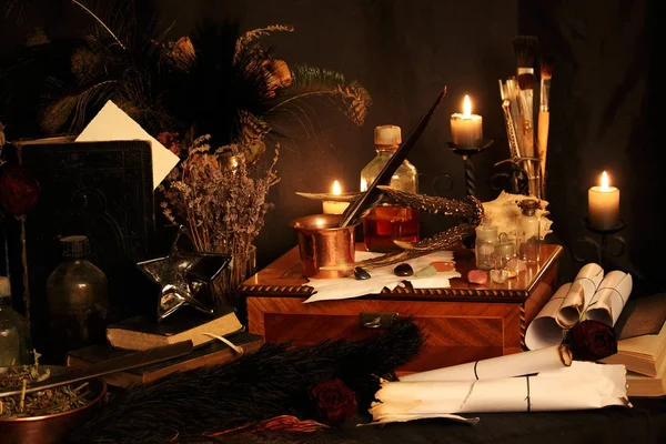 Kara büyü büyü. Wiccan büyüler ve otlar. Hala canlı: Eski yağ lambaları, antika kitap, bakır kase, ilaç şişeleri, lavanta, Pulsatilla pratensis bir antika arka plan üzerinde yanan bir muma gül tomurcukları kurutulmuş. Wicca arka plan.