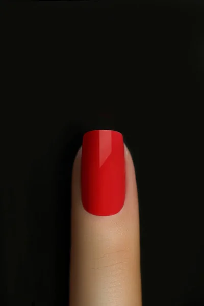 Red nail isolated on black. Finger point isolated white background.