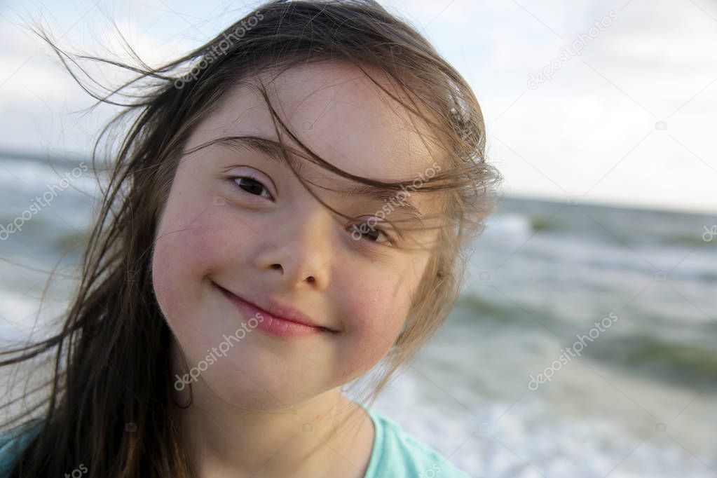 Portrait of the girl smiling on background of the sea
