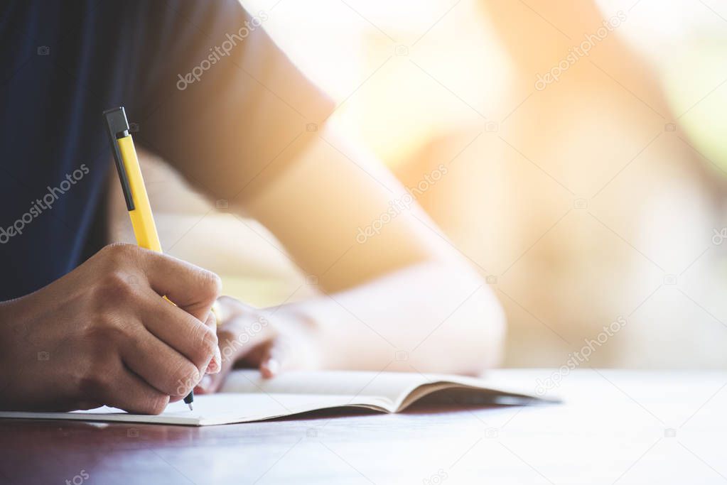 A young women writing on the notbook in the morning.