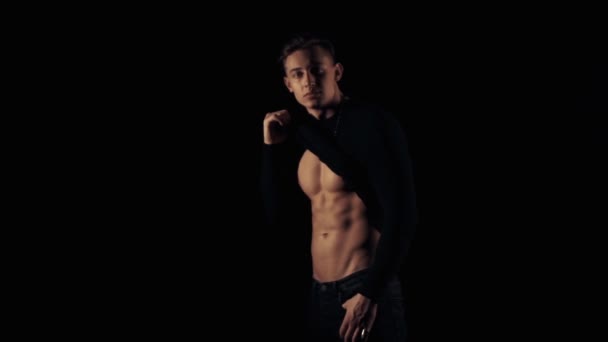 Sexy young man on black background — Stock Video