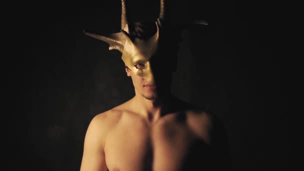 Mann mit Maske auf dunklem Hintergrund — Stockvideo