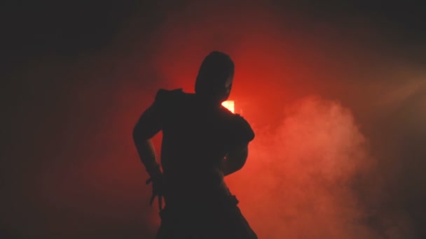 Silhouette of a dancing man in mask — Stock Video