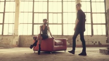 Lateksteki kadın ve koltuktaki adam