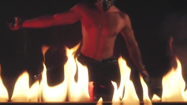 Sexy Man in mask dancing in fire — Stock Video