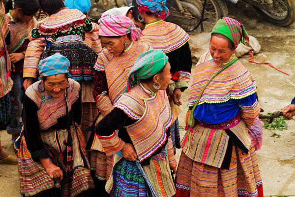 BAC HA, VIETNAM - SEPTEMBER 21: Unidentified women of the Flower H'mong Ethnic Minority People at market on September 21, 2012 in Bac Ha, Vietnam. H'mong are the 8th largest ethnic group in Vietnam.