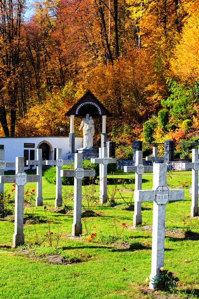 CZERNA, POLAND - OCTOBER 14: Crosses mark the graves of monks near the cloister in Czerna, Poland on October 14, 2013. Cloister itself is more than 300 years old.