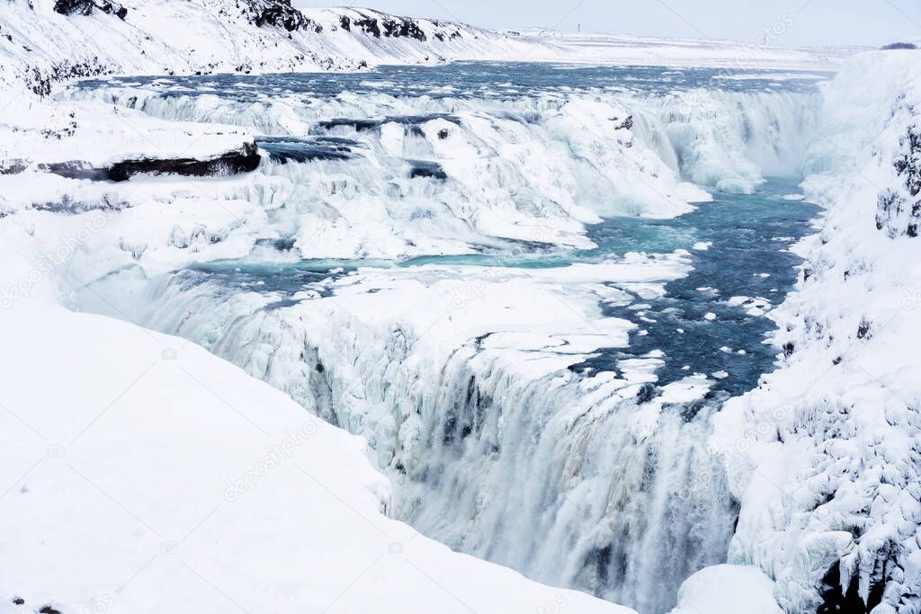 The Gullfoss Falls in Iceland in winter when the falls are partially frozen.