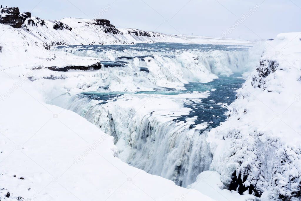 The Gullfoss Falls in Iceland in winter when the falls are partially frozen.