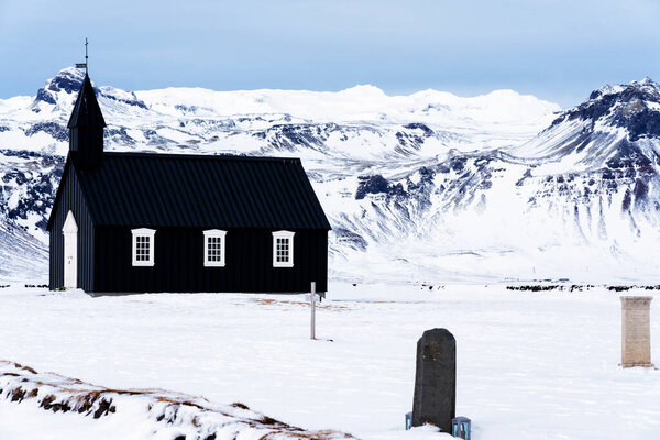 Beautiful minimalistic view of Budir black church in the Snaefellsnes peninsula during severe snowstorm