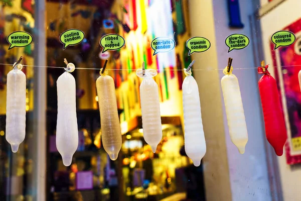 AMSTERDAM, THE NETHERLANDS - NOV 2, 2019. Funny condoms in a shop window. Warmoesstraat 141 - just on the border of the Red Lights district of Amsterdam.