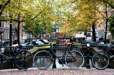 AMSTERDAM, NETHERLANDS - 10 Kasım 2019: Amsterdam, Hollanda 'daki köprüde park edilmiş geleneksel Hollanda bisikleti. Amsterdam 'da birkaç milyon bisiklet vardır..