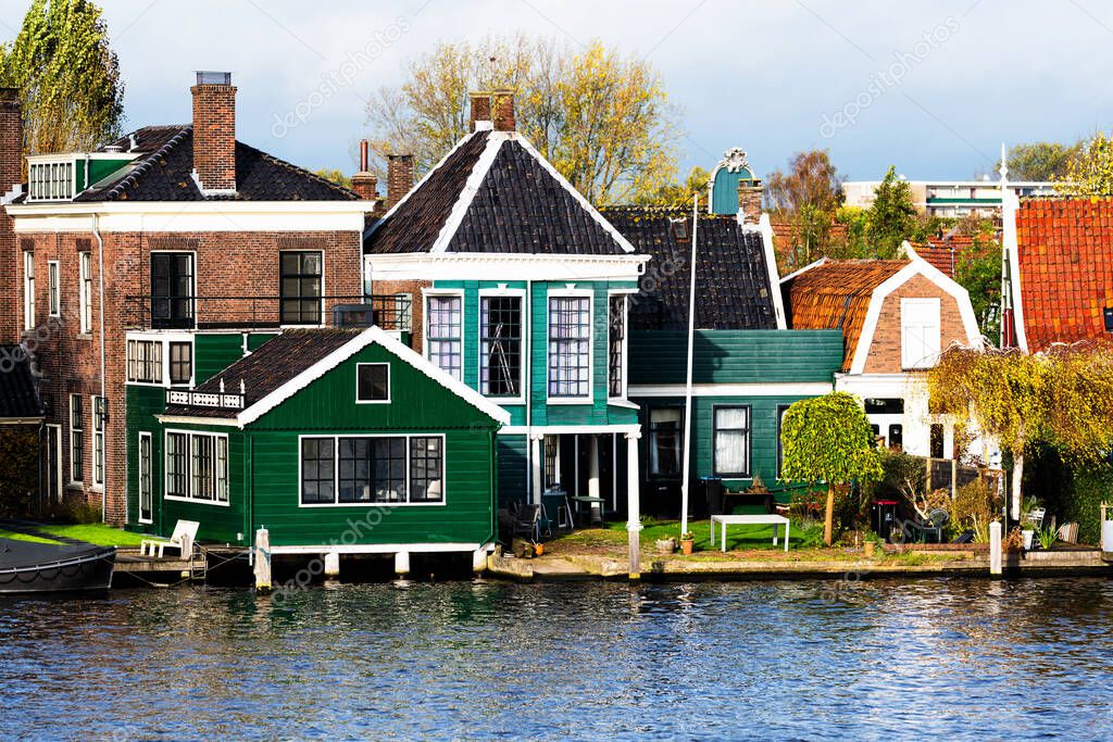 Picturesque view of traditional Houses by the Canal in the Historic Village of Zaanse Schans on the Zaan River in the Netherlands