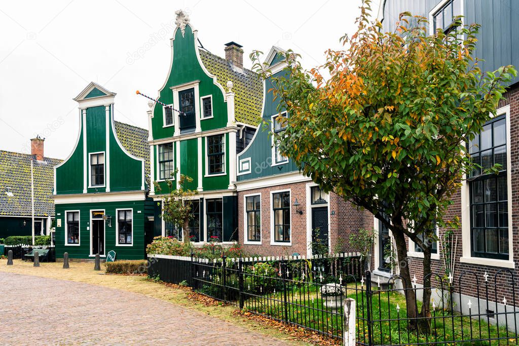 Picturesque view of traditional Houses by the Canal in the Historic Village of Zaanse Schans on the Zaan River in the Netherlands