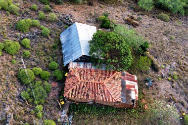 Farmhouse lodge in the rural mountainous part of Colombia located among rolling hills and coffee plantations. clipart