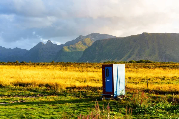 Outhouse or outdoor toilet building standing in a field, Lofoten Islands, Norway