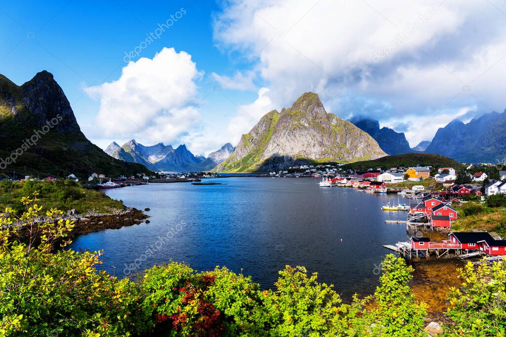Reine, Lofoten, Norway. The village of Reine under a sunny, blue sky, with the typical rorbu houses.