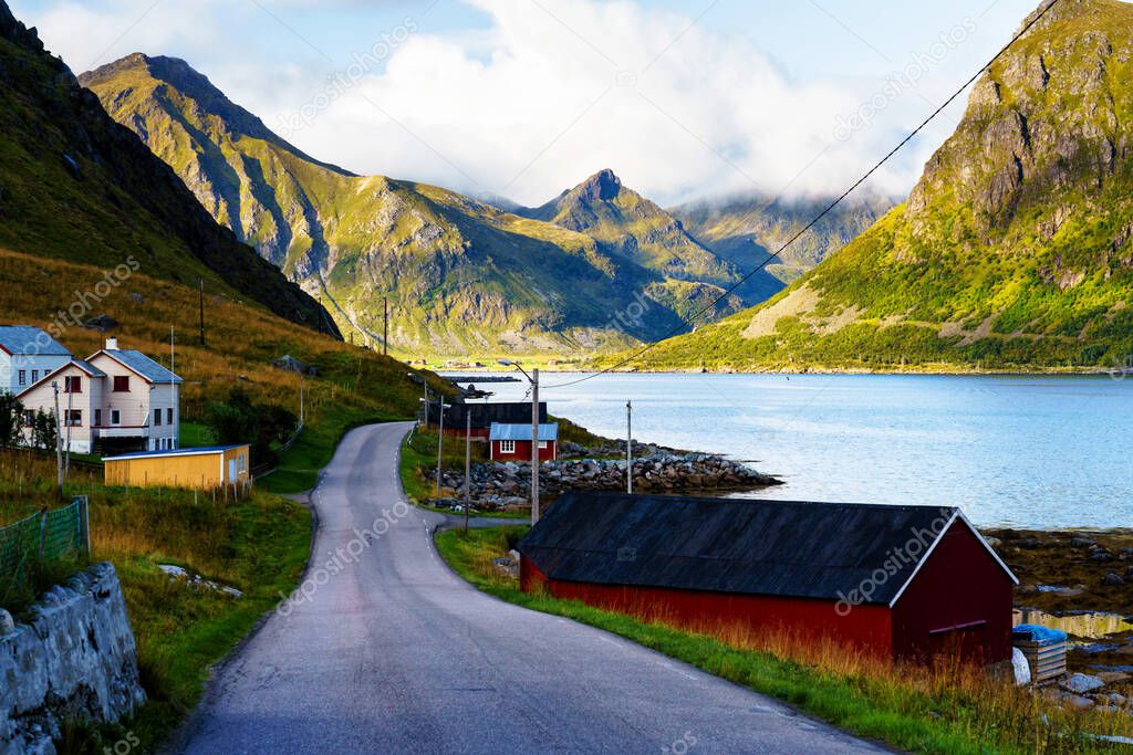 Norwegian coast landscape with a typical red houses. Wooden red houses are called rorbu or rorbuer and are used for fishermen or tourists. Lofoten, Norway