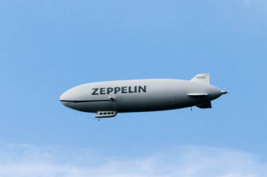 FRIEDRICHSHAFEN, GERMANY - AUGUST 19: Zeppelin dirigible airship up in sky in Friedrichschafen, Germany on August 19, 2014. clipart