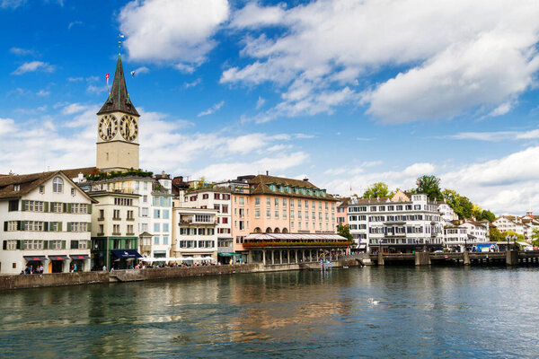 ZURICH, SWITZERLAND - AUGUST 25: View of Limmat river and famous Zurich churches in Zurich, Switzerland on August 25, 2014. Zurich is the biggest city and main economic center in Switzerland.