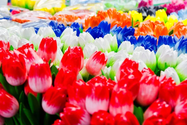 Traditional wooden colorful tulips in souvenir shop. Amsterdam, Netherlands