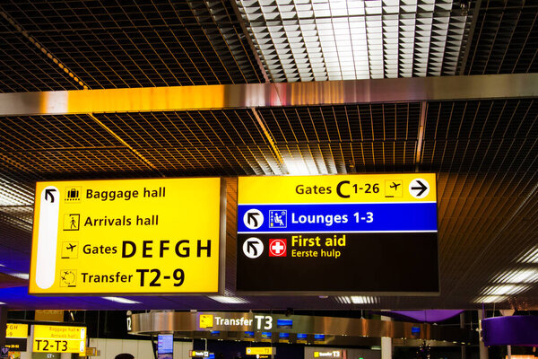 Illuminated airport departure gates direction sign