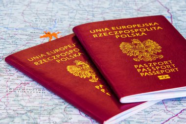 Passports over map background (showing Poland) clipart