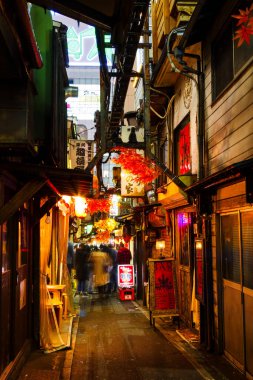 TOKYO, JAPAN - 16 Kasım 2015 'te Japonya' nın eski Shinjuku ilçesinde Yakitori sokağı olarak bilinen dar yaya sokağı. Burada birkaç geleneksel restoran var.