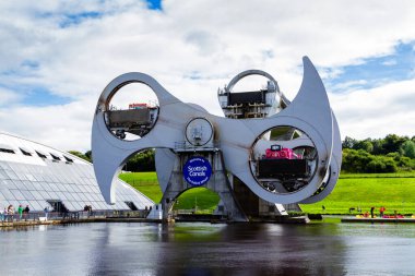FALKIRK, SCOTLAND - AUGUST 21, 2016: The Falkirk Wheel is a rotating boat lift connecting the Forth and Clyde Canal with the Union Canal. Scotland, United Kingdom clipart