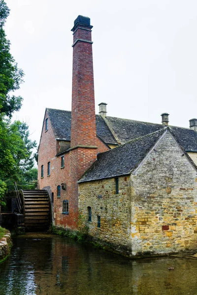 Old style English house and water mill in The Cotswolds know as Area Of Outstanding Beauty (AONB), England, United Kingdom, Europe