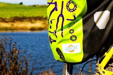 SOUTH ISLAND, NEW ZEALAND - CIRCA MARCH 2017: Green bicycle pannier mounted on a touring bicycle during cycling trip along New Zealand islands. Illustrative editorial. clipart