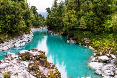 Hokitika Nehri 'nin mavi suları Hokitika Gorge Manzarası' ndaki kayanın yanında, batı kıyısında, Yeni Zelanda adasının güneyinde.