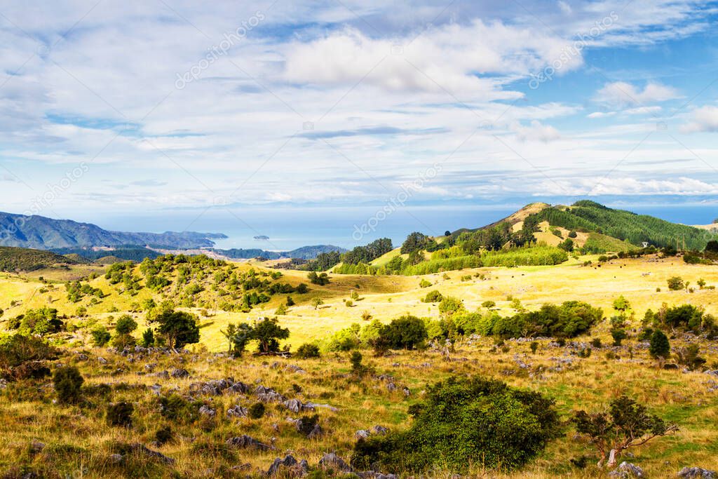 Beautiful farmland view in summer on South Island in New Zealand. View from Upper Takaka Pass near Abel Tasman National Park. Tasman Bay