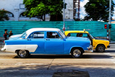 HAVANA, CUBA - 18 Kasım 2017: Havana, Küba sokaklarında eski renkli klasik araba. Ambargo nedeniyle Amerikan arabaları hala kullanılıyor ve turistler için taksi veya taşımacılık görevi görüyor.