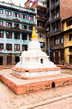 KATHMANDU, NEPAL, 11 Aralık 2018: Yerel binalarla çevrili bir avluda Budist stupası