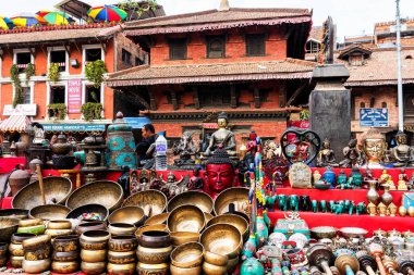 KATHMANDU, NEPAL - NOV 22, 2018: Shop of traditional Nepalese handicrafts and Religious statues, tibetan singing bowls for selling to pilgrims at the Patan Durbar Square clipart