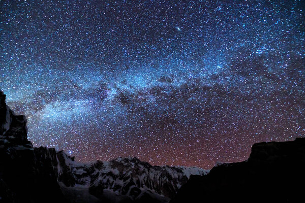 Млечный Путь и горы. Удивительная сцена с гималайскими горами и звездным небом ночью в Непале. Скалы со снежной вершиной и небо со звездами. Аннапурна. Ночной пейзаж с яркой молочной дорожкой