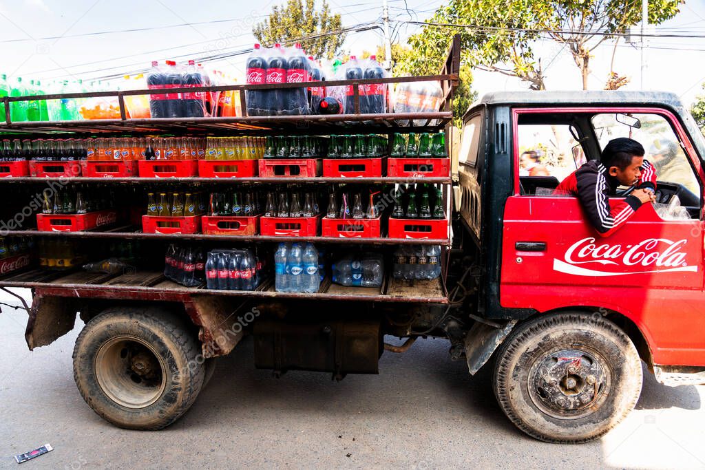 KATHMANDU, NEPAL - DEC 10, 2018: Old open truck delivers Coca Cola to local shops and vendors.