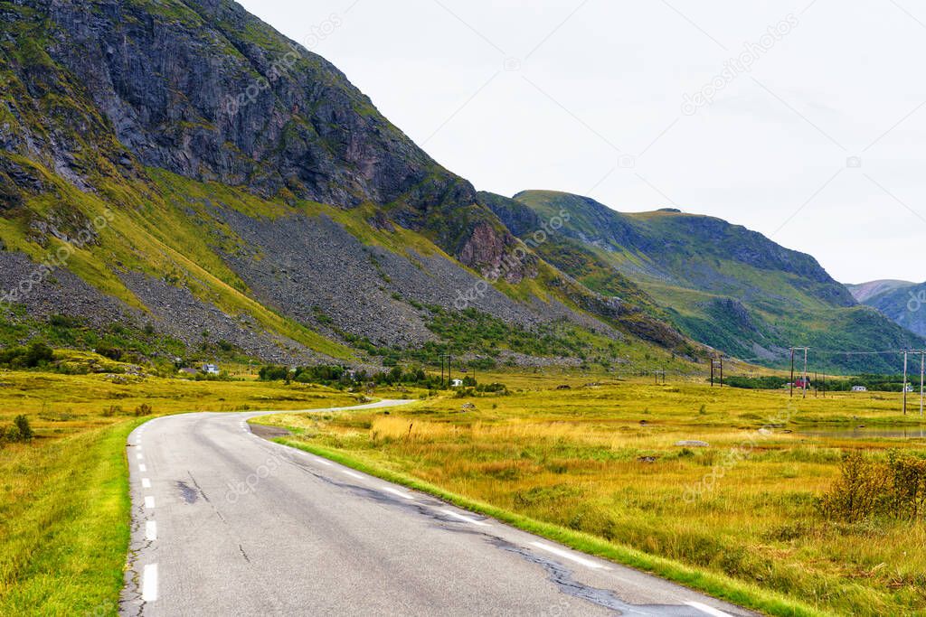 Scenic asphalt road through the beautiful view of mountain in Lofoten island, Norway during autumn. Concept of roadtrip, travel, vacation, adventure