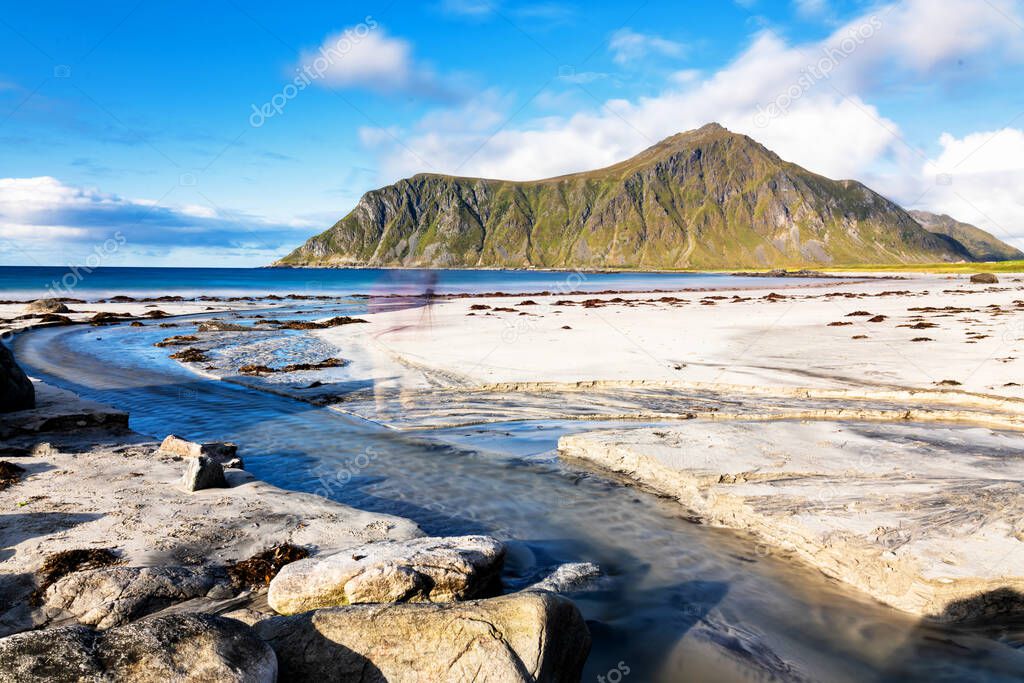 White sands washed by crystal turquoise water. Seascape views from Ramberg beach at Lofoten Islands, Norway