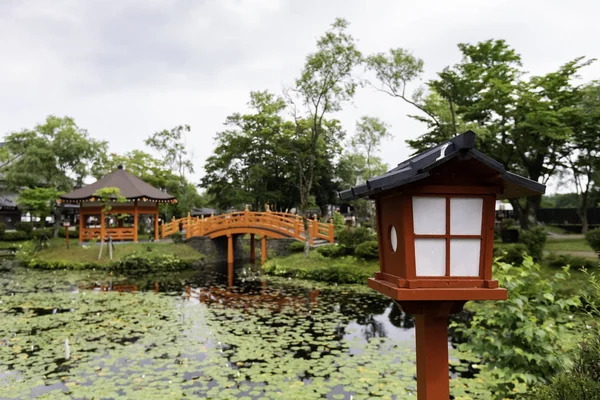 Japan lantern style near pond with bridge and pavilion