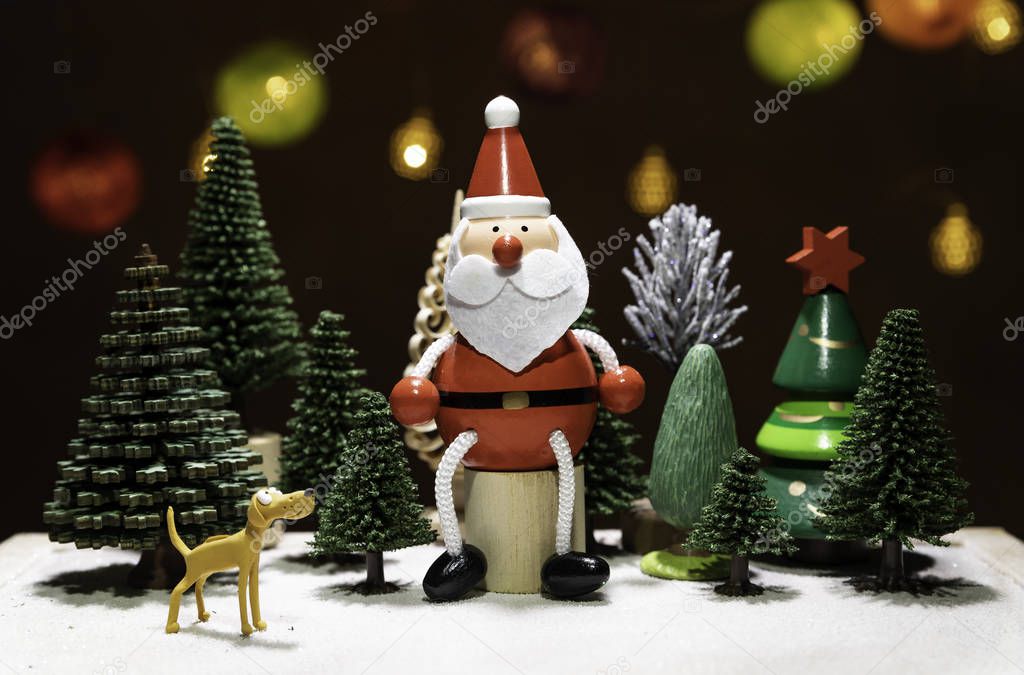 Santa Claus sit on circle wooden chair with dog watching among Christmas tree