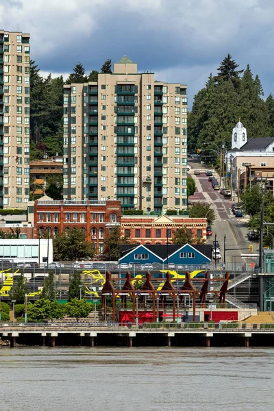 New Westminster British Columbia, The Center of City at the Waterfront of Fraser River. Promenade, multi-level parking lot, historic building, among the new high-rise buildings