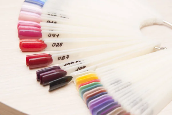 color palette of nail polish on tips in the manicure salon