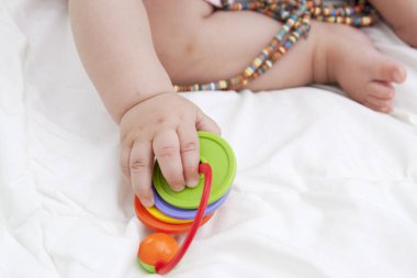 Bebeğin elinde renk oyuncak - ince moto gelişimi