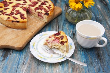 Çatallı bir tabaktabakta bir dilim süzme peynirli kek,