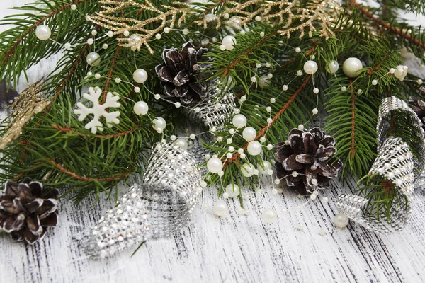 Christmas tree branches with cones, beads, snowflake. Fragment o — Stock Photo, Image