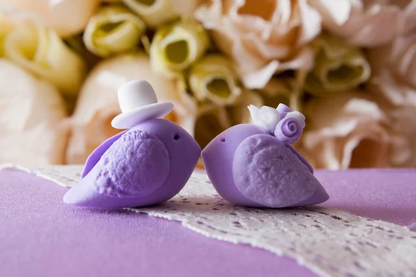 Wedding birds on a lilac background with flowers. Wedding day concept